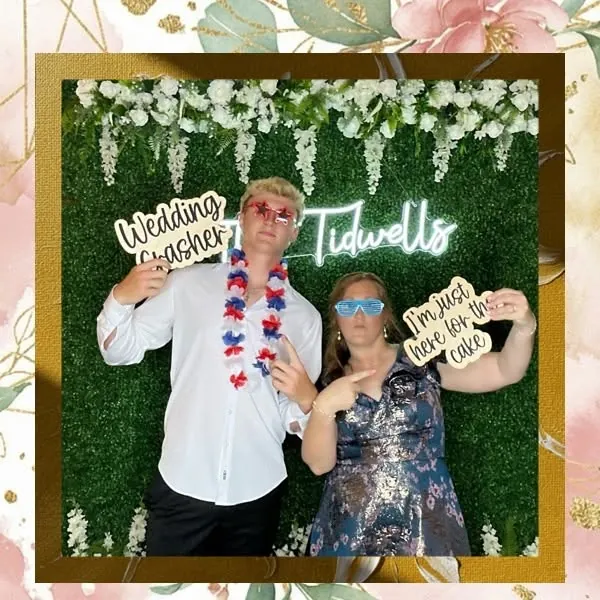 Wedding guests holding funny prop signs at a 256Snap photo booth in North Alabama